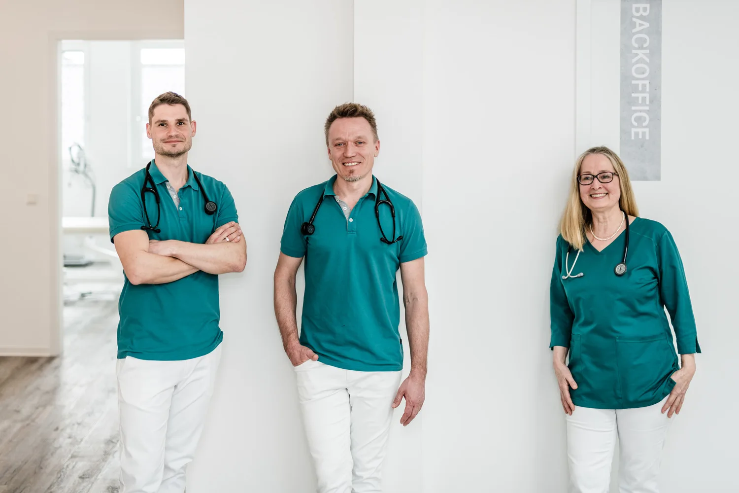Drei Ärzte des Teams im Flur der Praxis